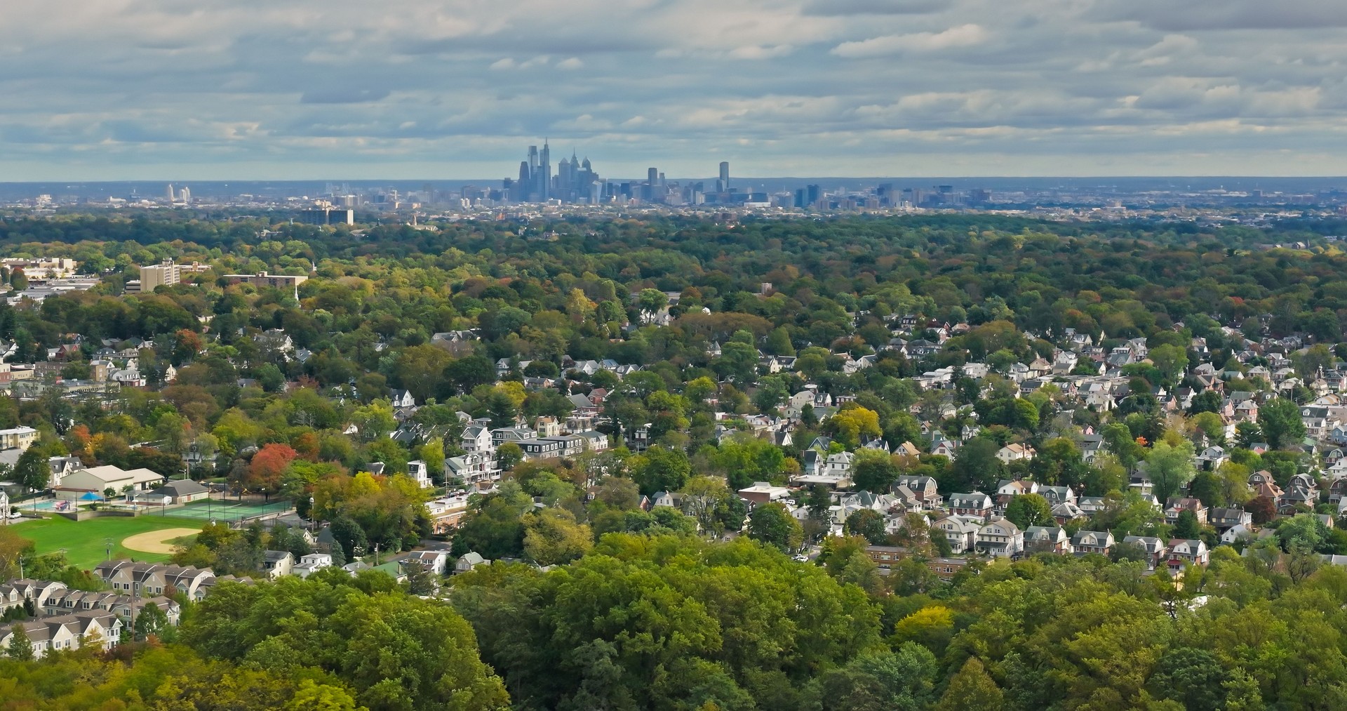 Drone Shot Looking Over Houses in Haverford, PA with Philadelphia Skyline in Distance